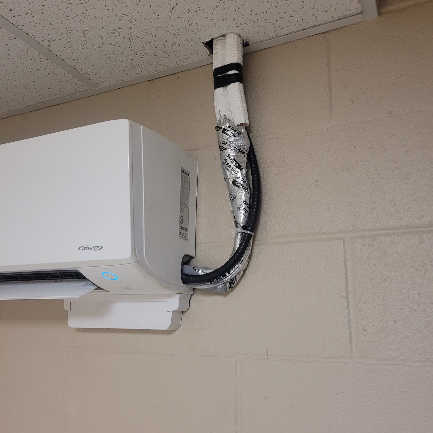 HVAC technician navigating tight clearances around ductwork